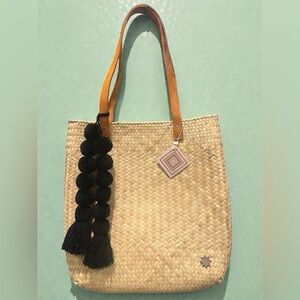 Handcrafted beach tote with leather handles and pom-pom!